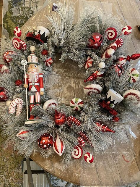 A few years ago I spotted a beautiful and festive Nutcracker wreath that I fell in love with on Pinterest and decided that I wanted to make my own version. After that, I started collecting peppermint candy themed decorations from mostly Hobby Lobby in the after holiday sales. This really helped to keep the costs down. All that remained to be purchase was the wreath, some bells, ribbon, a peppermint themed Nutcracker and pine boughs. I wanted a lush full look to the wreath and decided… Peppermint Candy Ornaments, Nutcracker Wreath, Christmas Nuts, Pine Boughs, Vintage Nutcrackers, Candy Wreath, Candy Ornaments, Nut Cracker, Themed Decorations