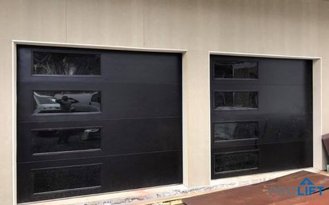 With a sleek and modern design, these Clopay steel garage doors are insulated too. The new doors are not only energy efficient, they're trending with a contemporary black finish and vertical window stack. | ProLift Garage Doors on Houzz | Photo and Project Credits: ProLift Garage Doors Haymarket Va Black Garage Doors, Contemporary Garage Doors, Contemporary Garage, Black Garage, Garage Door Windows, Garage Door Panels, Wooden Garage Doors, Sectional Garage Doors, Modern Garage Doors