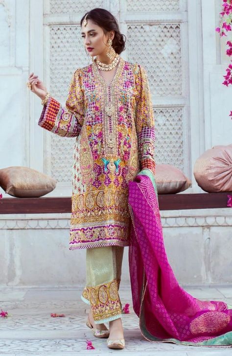 A ravishing, graceful and customary wedding wear kurta having heavy embellishments by Farah Talib Aziz. This elegant dress has the work of kora, dabka, resham, threadwork, embroidery and nakashi.  The dress is paired with traditional bottom work open trousers. Farah Talib Aziz, Mehndi Outfit, Pakistani Formal Dresses, Bright Color Dresses, Pakistani Party Wear, Salwar Kamiz, Pakistani Bridal Dresses, Pakistani Wedding Dresses, Pakistani Bridal Wear