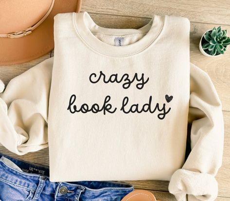 ABOUT OUR Crazy Book Lady Sweatshirt, Book Club Sweatshirt, Book Club Crewneck, Book Club Tee, Book Lover Shirt, Bookish Shirt, Bookish Sweatshirt, Book Lover Gift Sweatshirt: PRODUCTION TIME: 1-3 business days (Usually 2 business days) SHIPPING TIME: 2-5 business days (Usually 3 business days) PRODUCT DESCRIPTION: Gildan 18000 Sweatshirt Super soft cotton and excellent quality print makes. 50% Soft cotton (fibre content may vary for different colors) 50% Polyester  Light fabric (4.2 oz/yd² (142 Book Lover Aesthetic Outfits, Bookish Outfits, Sublimation Tees, Bookish Shirts, Bookish Tshirt, Book Nerd Shirts, Book Shirt, Lover Sweatshirt, Book Clothes