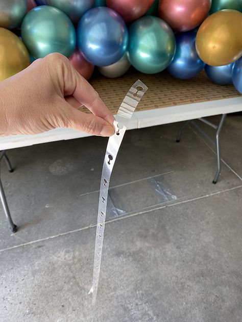 Balloon Garland On Pop Up Tent, Balloon Strip Garland, Balloon Garland On Fence, How To Use Balloon Tape Strip, Ballon Backdrop Simple, Balloon Garland On Backdrop Stand, Alternative To Balloon Arch, Straight Balloon Garland, Diy Balloon Weights Cheap