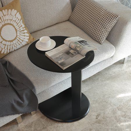 Sleek and ultra modern, this space conscious C-Shape end table brings a feel of minimalisn to your seating group. You will love this end table for its multiple uses and its modern comtemporary look, use it as side table, tray, drink table, night stand or while working with your laptop, yet it brings table top closer to you by sliding the circular base underneath your favorite sofa, chaise or bedside so you can have things you need closer to reach. Color: Black. Black C Table, Bedside Laptop Table Ideas, Tables For Sectional Sofas, Circular End Table, White Black Living Room Decor, Couch Tables Slide Under, Sectional Side Table Ideas, Sofa Side Table Design Modern, Black Sofa Decor Ideas