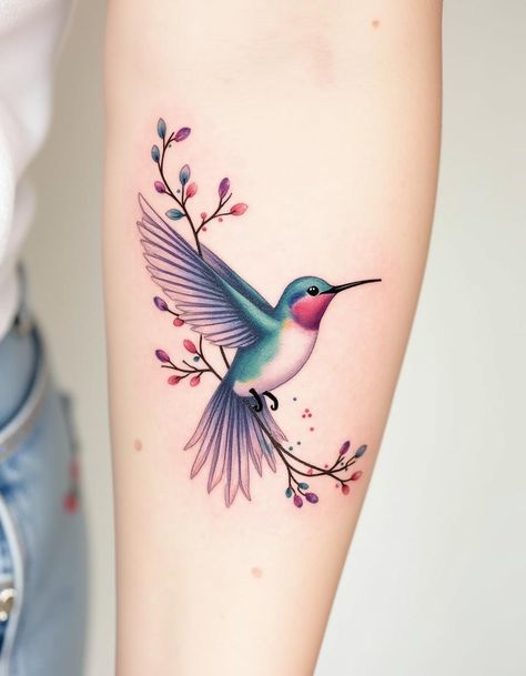 A delicate and vibrant watercolor tattoo design featuring a graceful hummingbird in flight, perched on a floral branch adorned with colorful leaves and buds. The soft, fluid color palette includes shades of pink, purple, blue, and green, creating a dreamy and elegant aesthetic perfect for nature and art lovers. Hummingbird Tattoo Color, Color Hummingbird Tattoo, Realistic Hummingbird Tattoo, Watercolor Hummingbird Tattoo, Hummingbirds Tattoo, Hummingbird Tattoo Design, Hummingbird Tattoo Black, Watercolor Tattoo Design, Lilac Tattoo