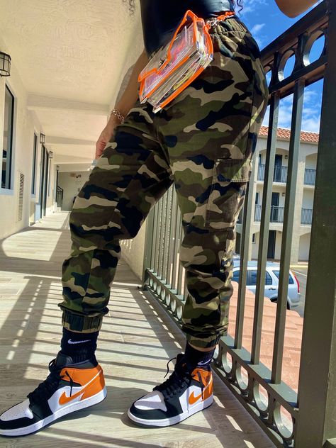 Orange and black Air Jordan 1 - Camo Pants - Leather top - leather bodysuit - Nike Camouflage And Orange Outfit, Black Jordan 1 Outfit Women, Jordan 1 Outfit Men Fashion, Orange Jordans, Outfit With Jordan 1, Outfit With Jordans, Black And Gold Jordans, Jordan 5 Outfit, Pretty Tomboy