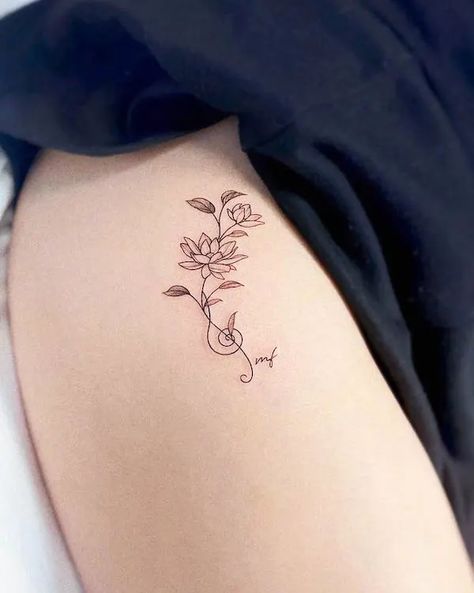 Wrap Around Music Tattoo, Lotus Flower Band Tattoo, Musical Flower Tattoo, Music Family Tattoo, Music Tattoo With Flowers, Lotus With Vines Tattoo, Elegant Lotus Flower Tattoo, Long Lotus Flower Tattoo, Music Tattoo For Women