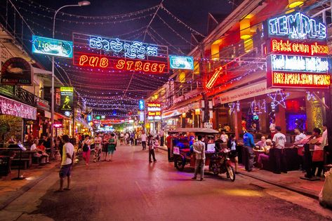 Pub Street Siem Reap is the nightlife hub of the town, featuring rows of backpacker-friendly bars and pubs, packed nightclubs and international restaurants. The street opens throughout the day and late into dawn. The main road – Street 08 – is where you can find the iconic bars and clubs and the liveliest atmosphere – they’re well-known Fancy Water, House Buying, Brick Oven Pizza, Popular Travel Destinations, Bars And Clubs, Siem Reap, Take Better Photos, Hill Station, Street Names