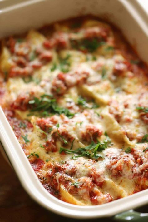 This delicious Baked Stuffed Shells Recipe is a fantastic pasta recipe for a Sunday night dinner. They are stuffed with flavorful ricotta cheese, simmered in a homemade tomato sauce, and topped with gooey mozzarella cheese. Easy Stuffed Shells With Meat, Stuffed Shells With Meat Sauce, Baked Stuffed Shells, Stuffed Shells With Meat, Easy Stuffed Shells, Entertaining With Beth, Sunday Night Dinner, Cheese Manicotti, Manicotti Recipe