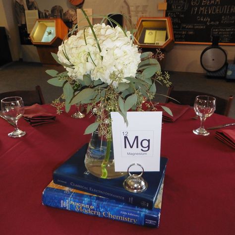 Clever centerpiece at Lawrence Hall of Science Chemistry Centerpiece, Science Centerpieces, Chemistry Wedding, Gala Centerpieces, Engineer Graduation, Teacher Retirement Parties, Science Wedding, Graduation Table, Marriage Retreats