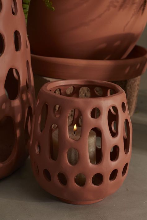 Create a dreamy outdoor space with the lightweight terracotta Alameda Lantern, featuring organic handmade cutouts. Place a citronella or pillar candle inside to ward off bugs & set the mood. Layer multiple sizes together for a cozy, dimensional glow. Specifications Product Dimensions: 7.25 x 7.25 x 7.75 Product Color: Terracotta Product Material: Ceramic Product SKU: 54800 Product UPC: 194444013174 Brand: Accent Decor Returns & Exchanges Non-returnable. Damaged items will be replaced. See full r Clay Lanterns Ideas, Pottery Lantern, Terracotta Products, Ceramic Lanterns, Clay Home Decor, Lantern Ceramic, Decor Pottery, Ceramic Lantern, Set The Mood