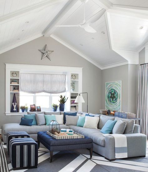 beige/sand walls, grey couch with blue cushions Beach Cottage Style Living Room, Coastal Casual Living Room, Coastal Style Living Room, Cottage Style Living Room, Beach Theme Living Room, Nautical Living Room, Sofa Ottoman, Coastal Decorating Living Room, Furnitur Ruang Keluarga