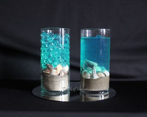 Planning a beach wedding? Sand, shells and #waterbeads in teal or blue make gorgeous, affordable centerpieces. Add water for a translucent look, or leave the crystal appearance of the beads—either way, your guests will be dazzled! Underwater Centerpieces, Centerpieces For Beach Wedding, Beach Centerpiece Ideas, Under The Sea Centerpiece Ideas Diy, Sand Centerpiece Ideas, Sand Centerpieces Wedding, Ocean Themed Centerpieces, Water Decor, Ocean Inspired Centerpieces