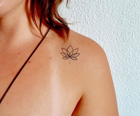 Discover charming and meaningful small tattoo ideas perfect for expressing your individuality. From delicate flowers to minimalist symbols, find the inspiration to adorn your skin with beauty and grace. Let your ink tell your story! 💖✨ #TattooIdeas #SmallTattoos #FemaleInk Lotus Tattoo On Shoulder, Lotus Tattoo Collar Bone, Brazil Tattoo Ideas Small, Lotus Collar Bone Tattoo, Shoulder Tattoo Minimalist, Lotus Minimalist Tattoo, Tiny Shoulder Tattoo, Lotus Shoulder Tattoos For Women, Lotus Tattoo Minimalist