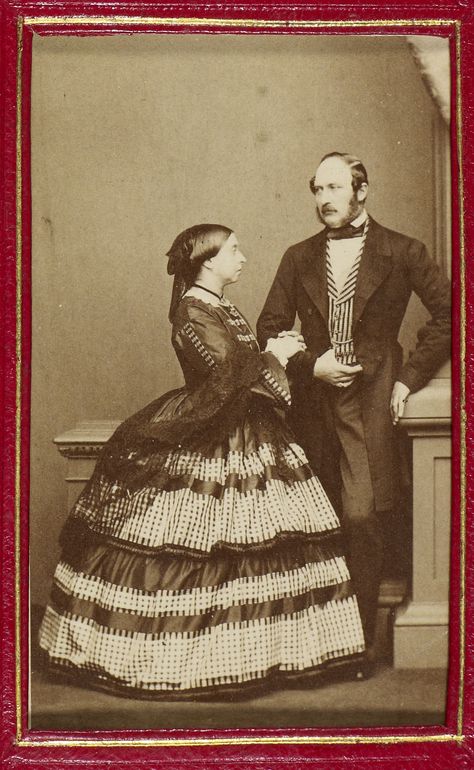 1861 March. Carte-de-visite photograph of Queen Victoria (1819-1901) and Prince Albert, Prince Consort (1819-61). They are both standing, she is facing the Prince and clasps his forearm and wears a tartan and checked dress with fringed shawl. Queen Victoria And Prince Albert, Prins Albert, Young Queen Victoria, Queen Victoria Family, Queen Victoria Prince Albert, Alexei Romanov, Royal Family Trees, Victoria Reign, Royal Collection Trust