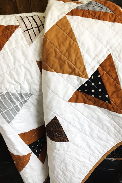 Great quilt for the Fall modern minimalist nursery. It's made with rich shades of brown mixed with linen fabrics in complementary colors giving it great texture.  It's perfect for a baby boy into his toddler years as a crib quilt, for tummy time, and snuggling on the couch. Would also be a striking wall hanging, lap quilt or over the back of a chair. Pattern is Mod Mountains by Suzy Quilts. #minimalistnursey #babyshowergift #modmountainsquilt #babyquiltforsale #Fallquilt #lapquilt #wallhanging Mod Mountains Quilt, Earth Tone Quilt, Boho Quilt Pattern, Modern Baby Quilts, Modern Boy Quilt, Modern Minimalist Nursery, Triangle Mountain, Brown Quilts, Boho Baby Quilt