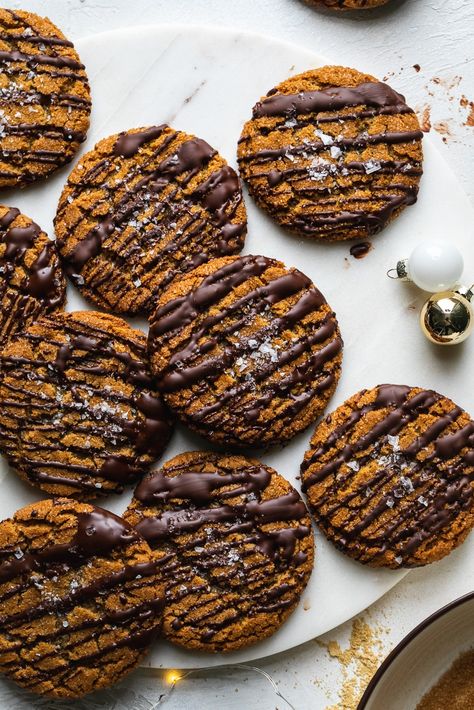 These Chewy Tahini Gingersnaps with Dark Chocolate and Sea Salt are a modern take on the classic gingersnap cookie! They're filled with rich molasses flavor, ginger, cinnamon, as well as an added twist - tahini! It adds a slight nuttiness, richness, and unexpectedly delicious depth of flavor! To finish, the cookies get drizzled with dark chocolate and flaky sea salt! #cookies #chewy #gingersnaps #tahini #darkchocolate Chewy Gingersnaps, Salt Cookies, Sea Salt Cookies, Cookies Chewy, Ginger Snap Cookies, Ginger Snaps, Molasses, Tahini, Sea Salt