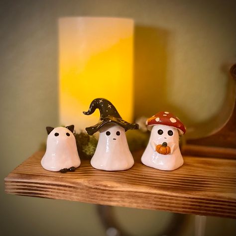 Add a playful twist to your Halloween decor with these adorable handmade  ghost figures, available in three unique styles: Ghost Cat, Ghost Witch, and Ghost Mushroom. Each figure is carefully crafted and hand-painted, bringing a touch of spooky fun and charm to your home. These ghostly characters are perfect for displaying on your mantel, shelf, or desk, adding a bit of festive spirit to any space. Whether you're a cat lover, a fan of all things witchy, or enchanted by the whimsical mushroom gho Cute Ghost Sculpture, Halloween Knick Knacks, Halloween Airdryclay Ideas, Cool Halloween Pumpkins, Hand Built Pottery Halloween, Mini Halloween Clay Ideas, Clay Ghost Tealights, Halloween Craft Gifts, Clay Crafts Simple