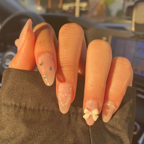 nails 2023, nail inspiration, nail inspo Pilates Princess Nails, Nail Design Charms, Pink Pilates Princess Nails, 3d Bow Nails, Almond Nails With Bow Charm, Bow Gem Nails, Bow Charm Nails, Bows And Pearls Nails, Nail Inspo 2023