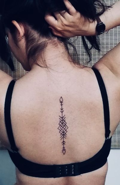 Geometric Arrow Tattoo On Spine Western Spine Tattoos For Women Simple, Triangle Spine Tattoo, Spine Tattoos For Women Arrow, Arrow Tattoo Back, Arrow Tattoo Back Spine, Geometric Arrow Tattoo, Back Tattoos Spine, Geometric Arrow, Arrow Tattoo