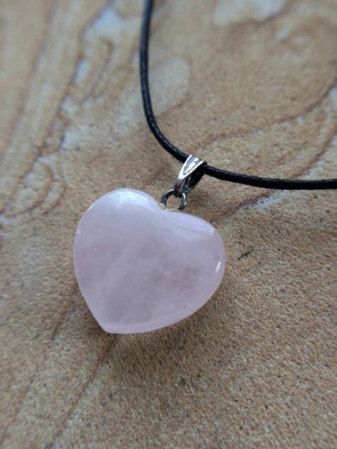 "Classic Rose Quartz Hearts! Each pendant will vary slightly due to naturally occurring patterns in the semiprecious stone. This pendant measures approx. 3/4\" long (top of bail to bottom of stone) and 1/2 to 5/8\" wide. Top drilled with a silver colored bail.  See photos for size reference. We have slightly larger hearts rose quartz hearts also available in our Etsy shop, see link below. Ready to wear, comes on a black cotton cord with slip knot for adjustable length or you may wear on your own Quartz Jewelry Diy, Cute Neckless, Heart Crystal Necklace, Ethereal Jewelry, Necklace Drawing, Slip Knot, Natural Stone Necklace, Pink Rose Quartz, Heart Shaped Necklace