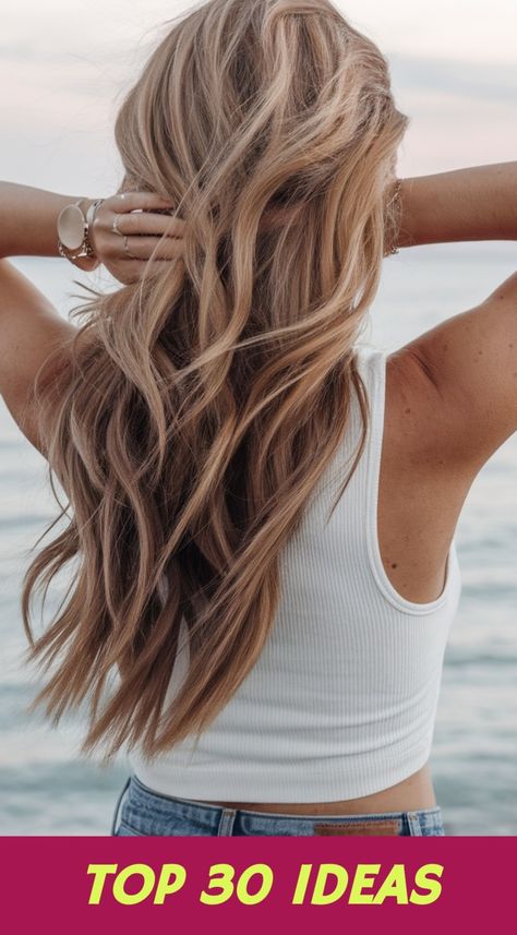 In this captivating image, a woman with long, flowing wavy hair stands against a picturesque seaside backdrop, embodying the essence of carefree summer vibes. The loose, tousled waves cascade down her back, creating a relaxed yet stylish appearance that is perfect for beach outings or casual gatherings. This hairstyle is suitable for various hair types and lengths, particularly those with medium to long hair. To achieve this look, consider... Hairstyles 2025, Medium To Long Hair, Tousled Waves, Beach Waves, Summer Look, Hair Types, Perfect Summer, Wavy Hair, Summer Looks