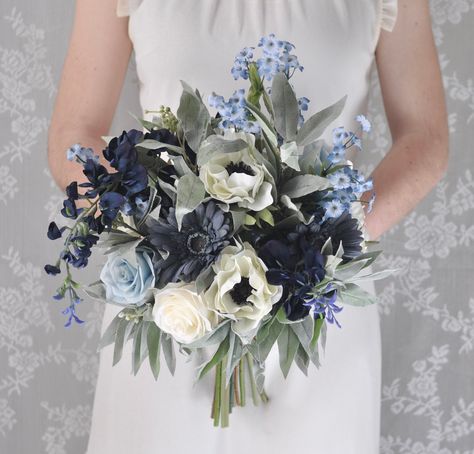 "CONGRATULATIONS on your upcoming wedding! This beautiful silk flower bridal bouquet is boho-inspired, with a stunning mix of white roses with blue wisteria and other faux/artificial flowers. Gorgeous eucalyptus greenery completes the look and all stems are flawlessly wrapped in ribbon of your color choice. Bouquet measures approx. 12\" across (although other diameters are available in drop down menu). Shown here tied with dusty blue ribbon, but if you are interested in luxurious silk ribbon, th Blue Wisteria, Holly Flower, Silk Flower Bridal Bouquet, Silk Flower Bouquet, Holly Wedding, Fresh Wedding Flowers, Richmond Wedding, Wedding Flower Design, Fav Products