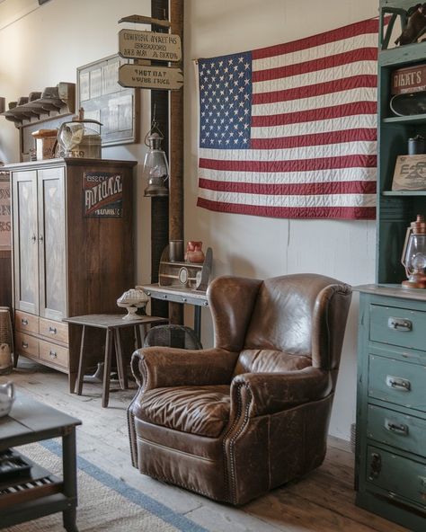 A cozy living room with vintage Americana decor, featuring a worn leather armchair, a quilted American flag on the wall, antique wooden furniture, and nostalgic memorabilia like old signage and rustic lanterns #americana #vintage #decor #rustic #nostalgic #antique Modern Americana Aesthetic, Old Americana Aesthetic, Antique Wooden Furniture, Vintage Americana Decor, Rustic Americana Decor, Mountain Cabin Decor, American Flag Wall Art, Americana Aesthetic, Rustic Americana