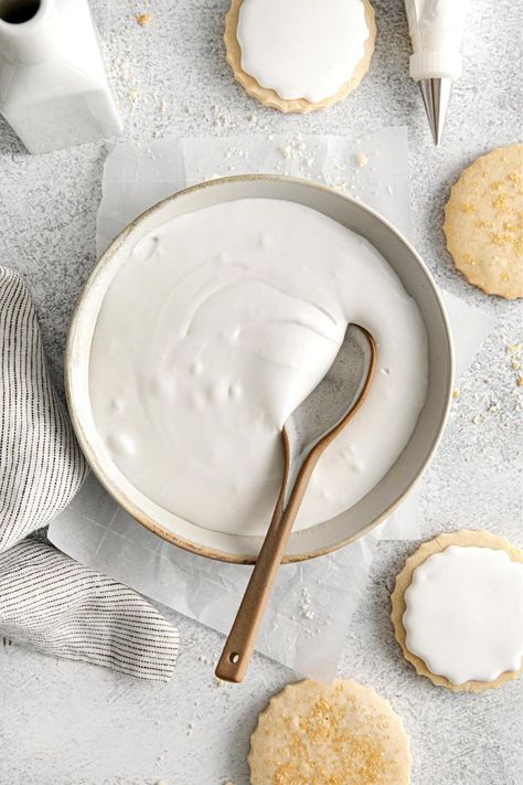 Homemade royal icing in a bowl with spoon next to frosted shortbread cookies and a piping bag fitted with a metal tip. Royal Icing For Cookies, Icing For Cookies, Cream Of Tartar Recipe, Icing For Gingerbread Cookies, Easy Royal Icing, Gingerbread House Icing, Decorating Sugar Cookies, Easy Royal Icing Recipe, Smooth Icing