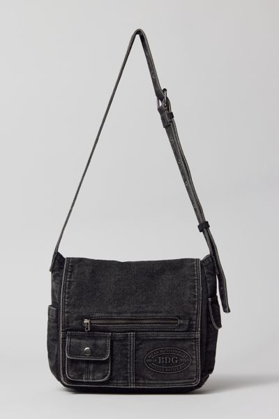 Essential messenger bag crafted from premium BDG denim. Low-profile silhouette with a pocketed flap closure. Lined interior with two pockets and plenty of space for your essentials. Complete with a zip pocket at the back for easy access, plus a water bottle pocket at the side. Finished with an adjustable strap wear it on your shoulder or crossbody. Urban Outfitters exclusive. Features. BDG denim messenger bag Washed soft denim with tons of storage Plenty of pockets inside and out Water bottle po Side Bags For Men Mens Fashion, Side Bag For Man, Urban Mens Fashion Streetwear, Downtown Boy, Cowboy Outfit For Men, Denim Messenger Bag, Messager Bag, Mens Messenger Bag, Black Messenger Bag