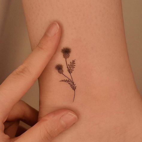 Thistle Outline Tattoo, Thistle Wrist Tattoo, Scottish Flowers Tattoo, Thistle Tattoo Meaning, Thistle Finger Tattoo, Flower Of Scotland Tattoo, Simple Scottish Tattoo, Small Thistle Tattoo Simple, Delicate Thistle Tattoo