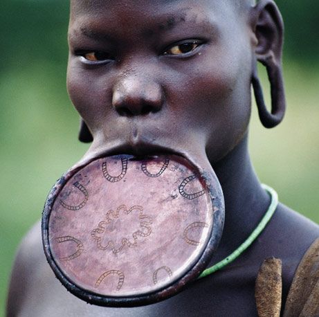 Lip Plate | lip plate is a form of body modification upon which an individual ... Mursi Tribe Ethiopia, Shaved Designs, American Heritage Girls, Mursi Tribe, We Are The World, Stretched Ears, World Cultures, People Of The World, Interesting Faces