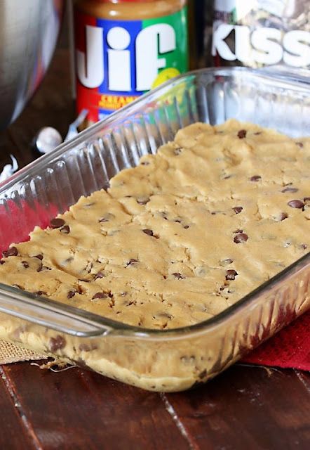 Peanut Butter Blossom Bars Dough Pressed into Baking Dish Image Recipes Using Peanut Butter, Blossom Bars, Peanut Butter Dough, Peanut Butter Blossom, Butter Cookie Dough, Amazing Cookie Recipes, Butter Desserts, Butter Blossoms, Caramel Rolls