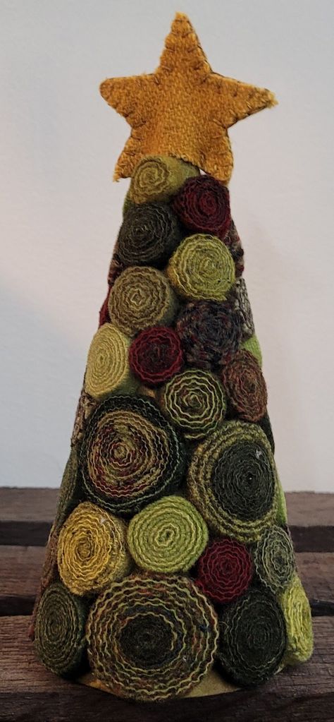 This festive tree is a lovely Christmas decoration that uses rich red and green wools that are 100% hand-dyed and have been washed and felted.  The finished tree measures approximately 3" x 7". Kit includes:  - precut wool strips  - precut wool star  - cone  - pattern  - assembly instructions Kit does not include adhesive. DISCLAIMER:  Materials in kits may vary from photo. Wool Trees Christmas, Wool Christmas Tree Diy, Hand Made Christmas Tree, Cone Trees Christmas Diy, Rag Trees How To Make, Fabric Trees Christmas Diy, Fabric Christmas Trees Diy, Wool Quillies, Wool Christmas Decorations