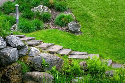 Using stones and plants to prevent soil erosion probably began with the second human-seeded crop at the base of a hill. The first crop got washed out! That’s why we’re … The post How to Place Rocks On a Slope to Stop Erosion – From Tiny Pebbles to Huge Stones appeared first on Outdoor Happens. Stepping Stone Paths, Backyard House, Path Ideas, Sloped Backyard, Backyard Buildings, Garden Stepping Stones, Sloped Garden, Easy Backyard, Stone Walkway