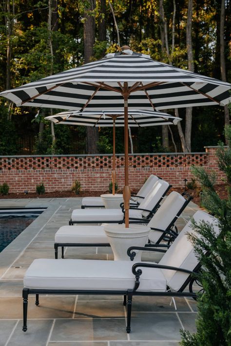 The Pool Furniture in Our Backyard Vacation Oasis Black And White Pool Furniture, Pool Party Dinner Food Ideas, Furniture Around Pool, Resort Pool Aesthetic, Black And White Pool Decor, In Pool Umbrella, Inground Pool Deck Decorating Ideas, White Pool Deck, Backyard Pool Cabana