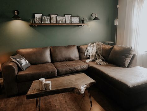 Green Living Room Brown Couch, Green Wall Brown Sofa, Dark Brown Coffee Table Living Rooms, Sage Green Living Room Brown Sofa, Green Wall Brown Couch, Green And Dark Wood Living Room, Dark Green Rustic Living Room, Green Living Room Brown Sofa, Brown Sofa Green Walls