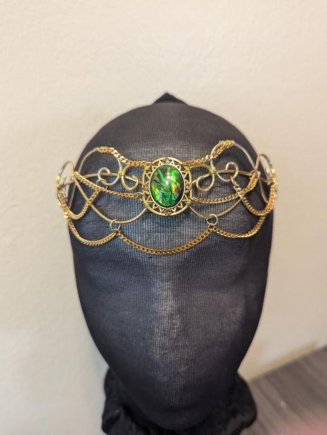 One of a kind green and gold headpiece. Beautiful circlet made from gold metal wire with wire wrapping accents and green gem. The perfect edition to the right outfit. All of my pieces are handmade.   Made with permanently colored artistic wire. The wire can be bent out of shape if care isn't taken. LOOK IN MY SHOP FOR POSSIBLE DISCOUNT COUPON CODES Fae Crown, Gold Circlet, Elven Circlet, Princess Fairy, Crown Gold, Gold Headpiece, Green Gem, Artistic Wire, Green Gems