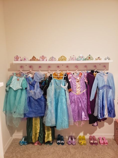 Princess Dress Display, Princess Dress Hanging Rack, Rainbow Princess Bedroom, Diy Princess Dress Rack, Disney Princess Playroom, Princess Dress Organization, Toddler Disney Princess Room, Disney Princess Room Aesthetic, Princess Dress Up Corner