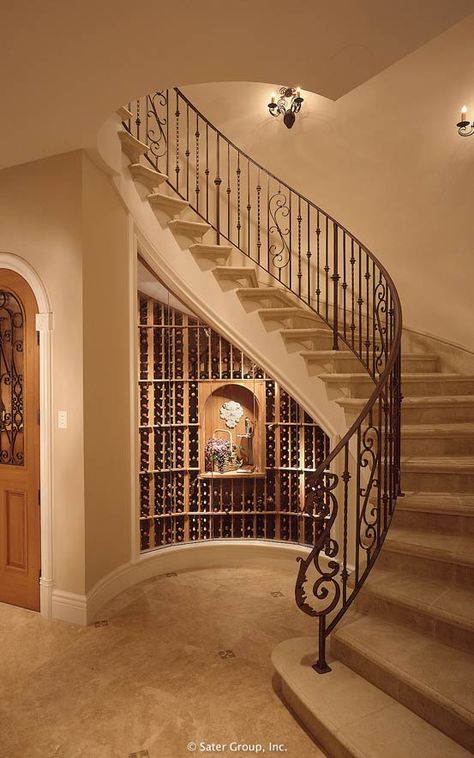 The curved main staircase shelters the wine cellar below. سلالم حلزونية, Luxury Staircase, Circular Stairs, Traditional Staircase, Stairs Design Interior, Home Wine Cellars, Stair Railing Design, Stairway Design, Stairs Design Modern