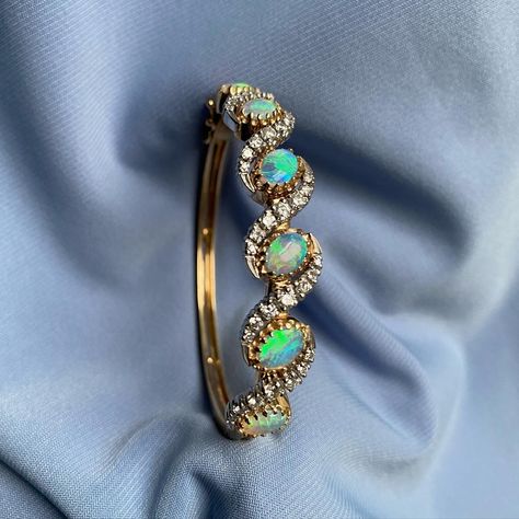 This one is special! The most gorgeous opal + diamond hinged bangle. Will definitely shed a few tears if it sells, because swipe and see how perfect it goes with my stack. 🥲🥲 Now available. 6.25” inside circumference, oval in shape. 14k gold, 18 grams. $2500 Hinged Bangle, Hinges, Shed, Opal, Bangles, 10 Things, Gold, Instagram