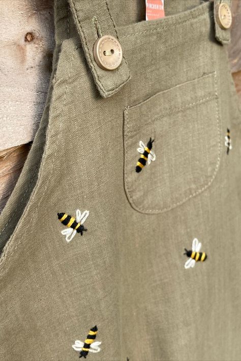 Who agrees that the only thing cuter than little linen dungarees are little linen dungarees with hand embroidered bees? 🐝 They also happen to be a clue for something exciting coming soon… keep an eye out! Shop hand embroidered, sustainable, upcycled adult and children's clothing as well as embroidery hoop decor and PDF patterns on Etsy: https://www.etsy.com/uk/shop/Pincushionembroidery Linen Dungarees, Embroidered Baby Clothes, Hoop Decor, Embroidery Hoop Decor, Minimal Shirt Design, Bee Embroidery, Baby Sewing Projects, Pola Sulam, Embroidery On Clothes