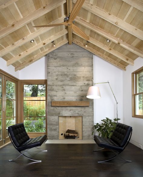 Living Room by Arcanum Architecture | concrete fireplace surround | exposed wood ceiling | masculine living room | black midcentury chairs | dark wood floor | glass doors | wood shelf over fireplace | home decor | interior design | Fireplace Woodburner, Fireplace Romantic, Whitewash Fireplace, Concrete Living Room, Fireplace Classic, Fireplace Candles, Fireplace Winter, Fireplace Apartment, Vaulted Ceiling Ideas