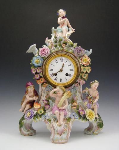 DRESDEN FIGURAL PUTTI PORCELAIN CLOCK: Meissen quality, with 4 applied putti representing the 4 seasons. French movement signed Vincente et Cie in bronze medallion. Cast cherub face pendulum. Measures 18'' h. x 12'' x 7'. Cherub Face, The 4 Seasons, Meissen Porcelain, Dresden Porcelain, Retro Clock, Maker’s Mark, Price Guide, 4 Seasons, Mantel Clock