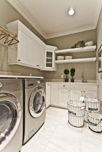 Another windowless laundry room that nonetheless feels attractive and light. Contemporary Laundry Room, Laundry Room/mud Room, Basement Laundry Room, Dream Laundry Room, Basement Laundry, Space Dividers, Small Laundry Room, Small Laundry, Laundry Room Storage