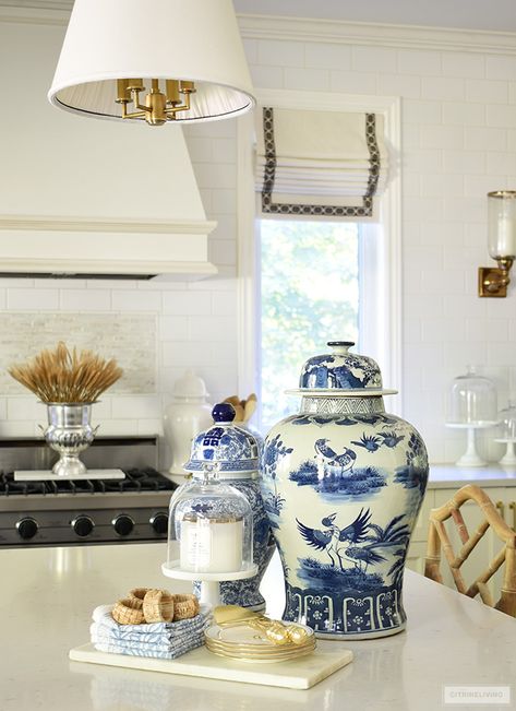 Blue and white ginger jars styled on a kitchen island with a marble tray and pretty dishes creates a chic display. Styling Ginger Jars, Ginger Jars Decor Kitchen, Fall Blue And White Decor, Blue White Kitchen Decor, Blue And White Kitchen Decor Ideas, Blue And White Jars Decor, Blue And White Dishes Display, White Ginger Jars Decor Living Rooms, Blue And White Kitchen Decor