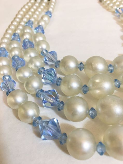 "Vintage 4 Tier White & Blue Crystal Bead Necklace; Vintage Graduating Bead Necklace; Vintage Stacking Bead Necklace; Vintage Bead Necklace Nice vintage enamel pearl bead collar necklace. Measures 16.\" at the neck. Has 4 strands of graduating white pearl enamel beads with blue glass Rondell beads. Each extension drops 1/2\". Beads measure from 1/8\" up to 1/2\" and in a graduating design. Looks like the original hook. The hook shows wear to it. No stamps or signatures. Preowned gently worn with Bead Collar Necklace, Beaded Collar Necklace, Beach Necklace, Pearl Stone, Vintage Beads Necklace, Beach Necklaces, Crystal Bead Necklace, Enamel Beads, Beaded Collar