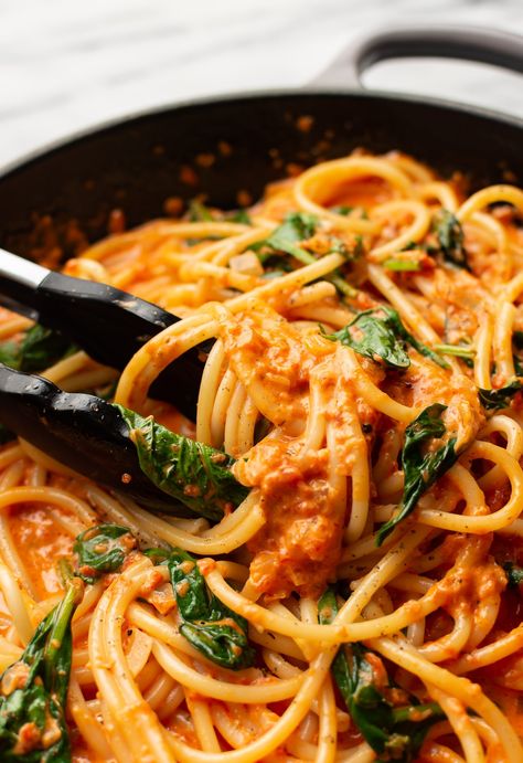 closeup of serving tongs in a skillet with roasted red pepper pasta Roasted Red Pepper Pasta With Chicken, Creamy Roasted Tomato Pasta, Roasted Red Bell Pepper Pasta, Jarred Roasted Red Pepper Recipes, Recipes With Roasted Red Peppers, Red Pasta Sauce Recipes, Roasted Pasta Sauce, Roasted Red Pepper Recipes, Pasta With Roasted Red Peppers