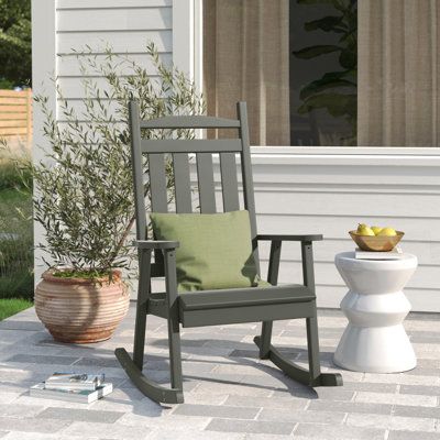 With an option between bright colors and neutral tones, this rocking chair is sure to make a statement on your patio or porch. It's made from solid pine wood and features a slat back with a curved top rail to create a classic coastal farmhouse silhouette. The slatted seat has a waterfall edge to add an extra dose of comfort. Two rockers and an open armrest, let you rock from sunrise to sunset. Color: Olive Gray | Sand & Stable™ Dempsey Classic Porch Rocking Solid Wood Chair Wood in Gray, Size 45 Farmhouse Silhouette, Classic Rocking Chair, Cedar Stain, Plastic Lumber, Rocking Chair Porch, Wood Rocking Chair, Classic Coastal, Solid Wood Chairs, Patio Rocking Chairs