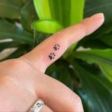 Tiny Inner Finger Tattoo, Small Paw Print Tattoo Finger, Finger Tattoos Paw Print, Dog Paw Finger Tattoo, Two Paw Print Tattoo, Cat Paws Tattoo Small, Small Pawprint Tattoos, Paw Print Tattoo On Finger, Finger Tattoos Cat