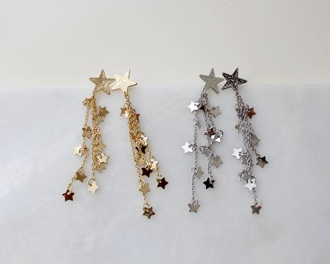 "more Gold dainty earrings in DearDanielleJewelry: https://www.etsy.com/shop/DearDanielleJewelry?ref=seller-platform-mcnav§ion_id=29399371 Shooting Star Earrings,Celestial Dangle Earrings. Star cascade, Star fall earring. Gold starry. Tiny sparkling little stars. 5/8\" diameter hammered gold plate star, 3\" drop Please choose your star color : Gold. Silver **framed gems, and charms in the jewelry is plated. *All the jewelry in my shop will be sent in cotton pouch. If you want gift box wrapping, Fall Earring, Star Earrings Dangle, Gold Star Earrings, Silver Star Earrings, Earrings Star, Starburst Earrings, Earring Gold, Sparkly Earrings, Fall Earrings