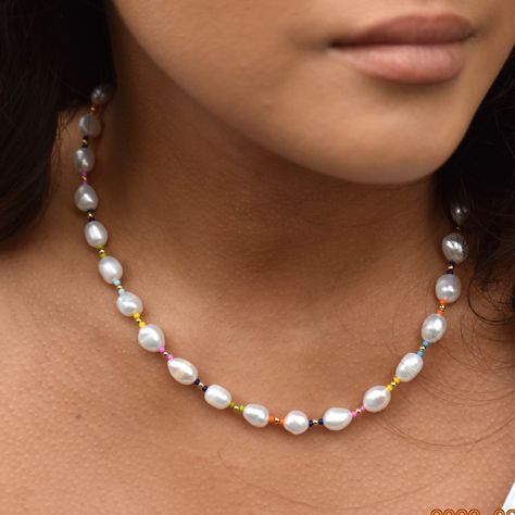 High quallity AAA* quality classical baroque pearl necklace with a modern 'twist'. This unique baroque necklace has been designed in our Bristol studio as a 'timeless classic' with a modern 'twist'. Pearls are hand selected for their AAA* quality and high luminosity. Accented with tiny dots of colourful and gold-filled beads this creates a stunning effect. Pearls are an essential in everyone's wardrobe and look fabulous with casual cashmere sweaters and shirts or for more dress-up occasions with Pastel Pearl Necklace, Pearl Jewellry, Beads Aesthetic, Unique Pearl Necklace, Baroque Necklace, Jewelry Necklace Simple, Homemade Necklaces, Beads Craft Jewelry, Pearl Necklace Designs